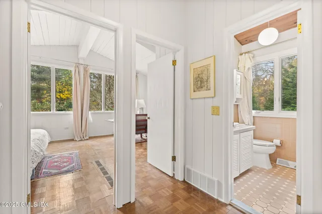 a bathroom with a granite countertop sink and a toilet