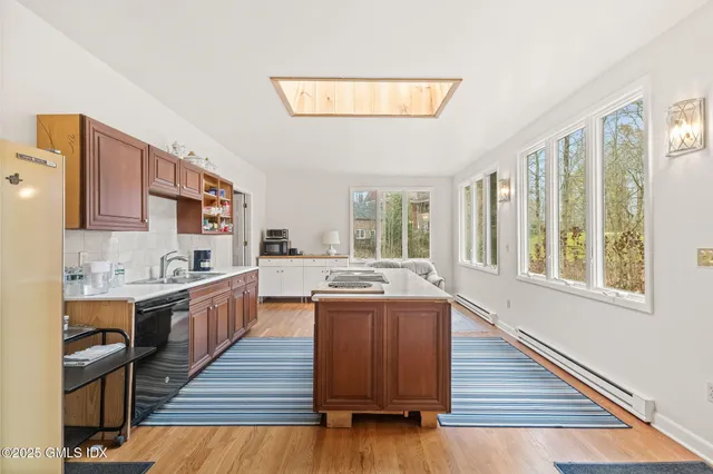 a kitchen with stainless steel appliances granite countertop a stove and a wooden floors