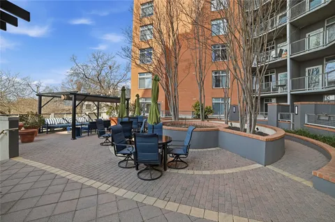 a view of a patio with dining table and chairs with wooden floor and fence
