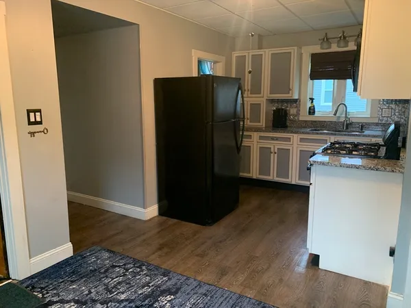 a kitchen with a refrigerator and a sink