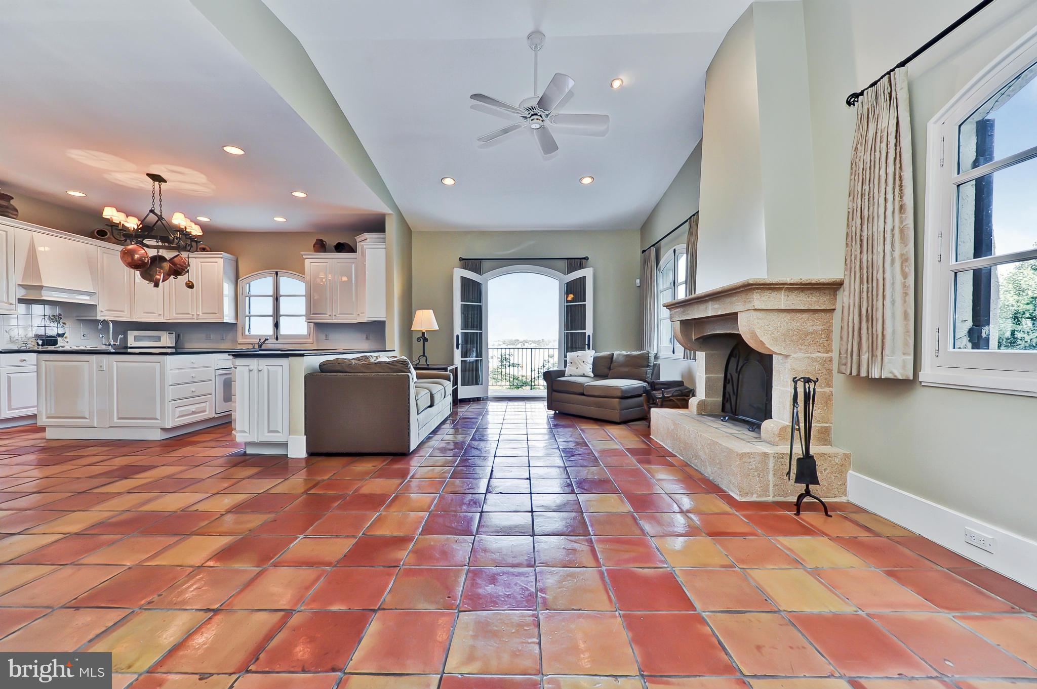 7608 Southdown Road Alexandria, VA 22308 - Photo 11 of 30 a view of a kitchen with kitchen island stainless steel appliances refrigerator sink cabinets and a window