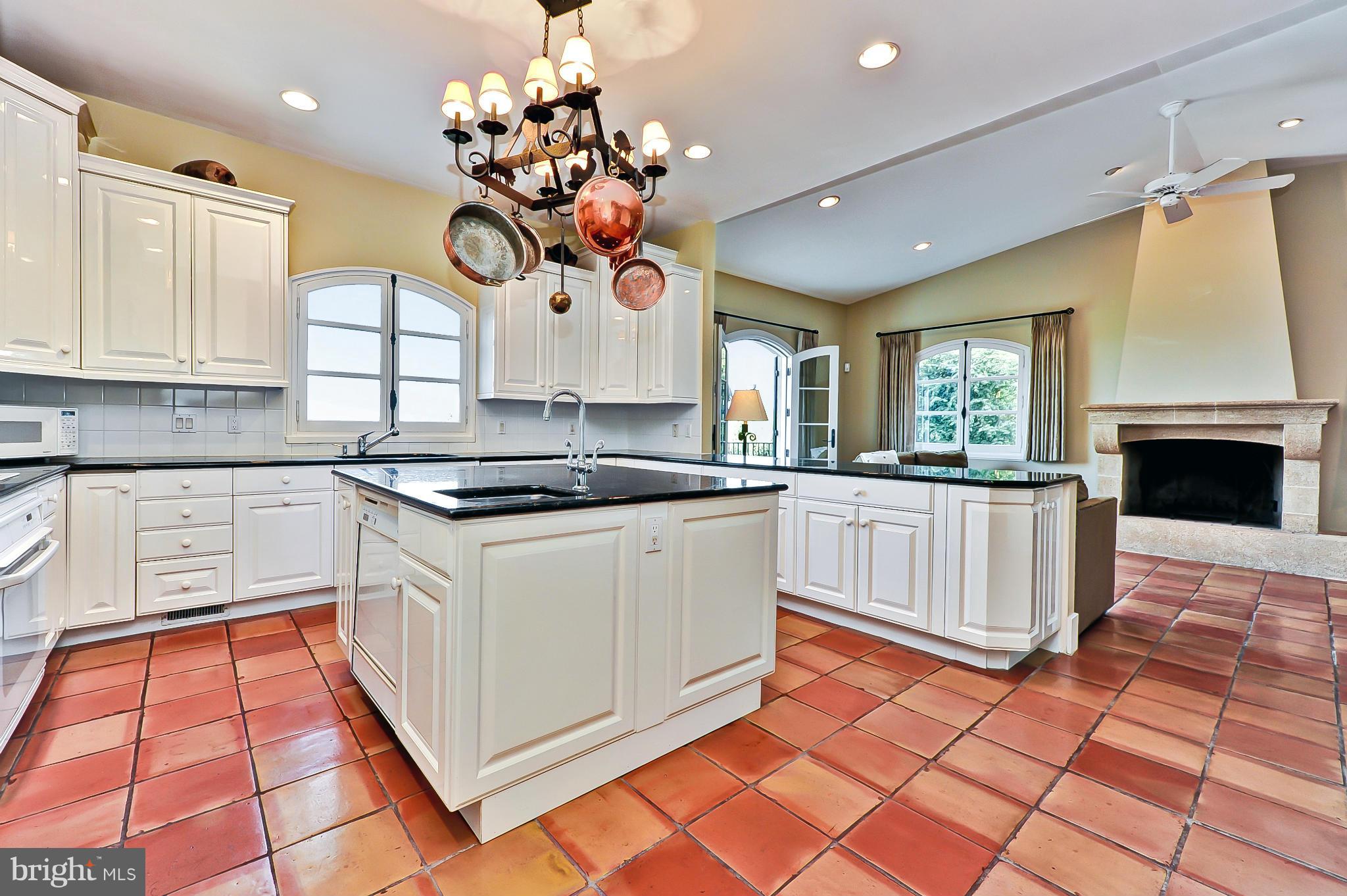 7608 Southdown Road Alexandria, VA 22308 - Photo 12 of 30 a kitchen with stainless steel appliances granite countertop a stove a sink and a microwave