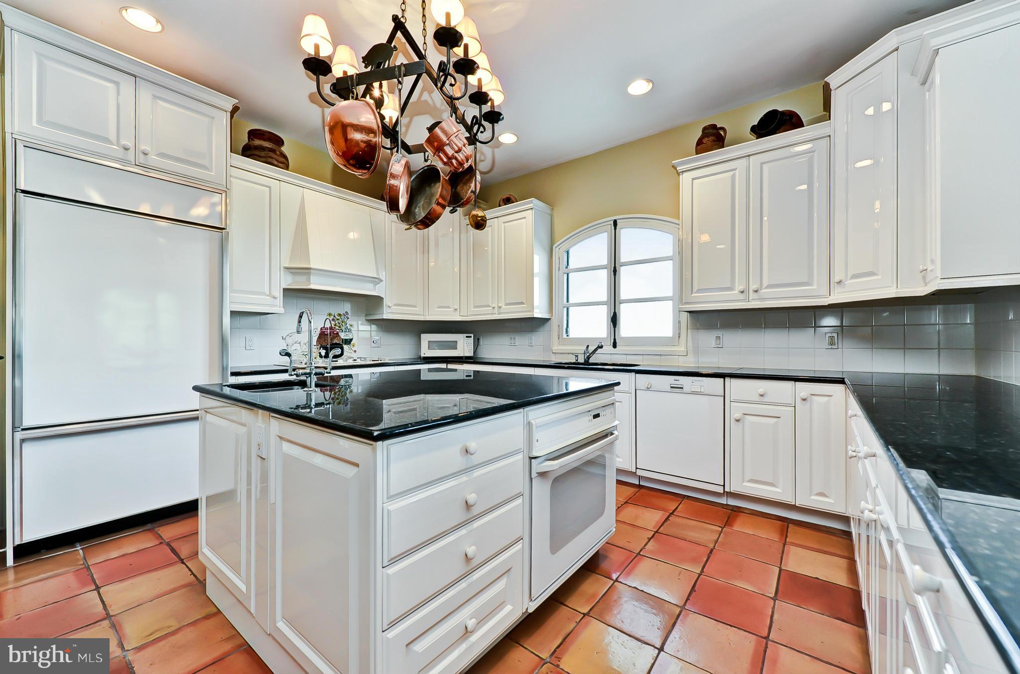 7608 Southdown Road Alexandria, VA 22308 - Photo 13 of 30 a kitchen with stainless steel appliances granite countertop a sink a stove and a refrigerator