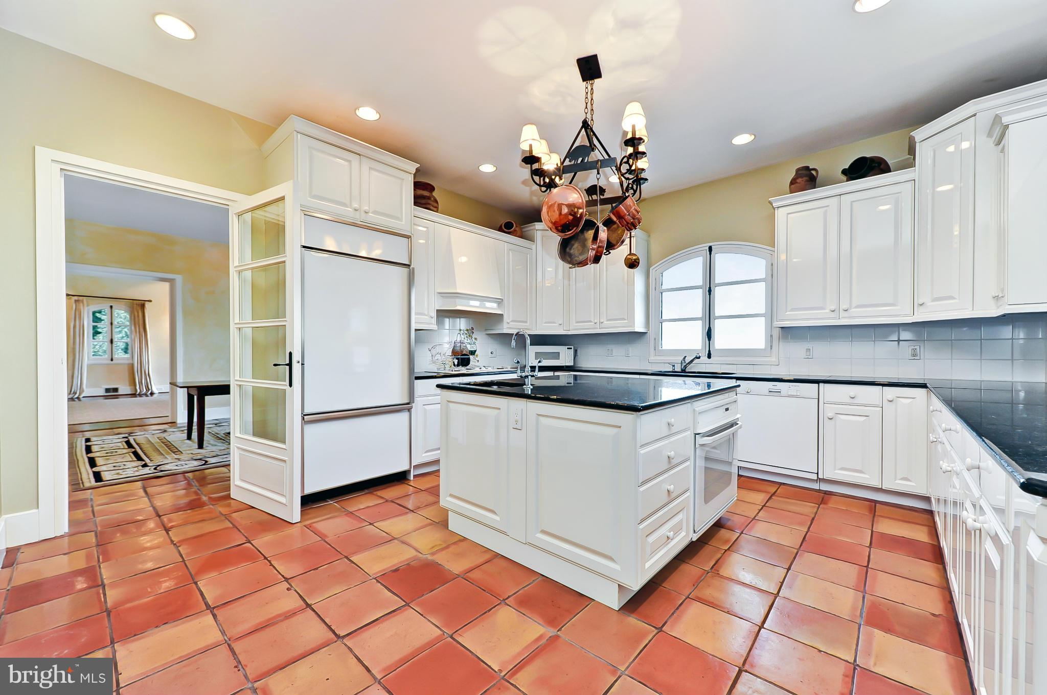 7608 Southdown Road Alexandria, VA 22308 - Photo 14 of 30 a kitchen with stainless steel appliances granite countertop a stove a sink and a refrigerator