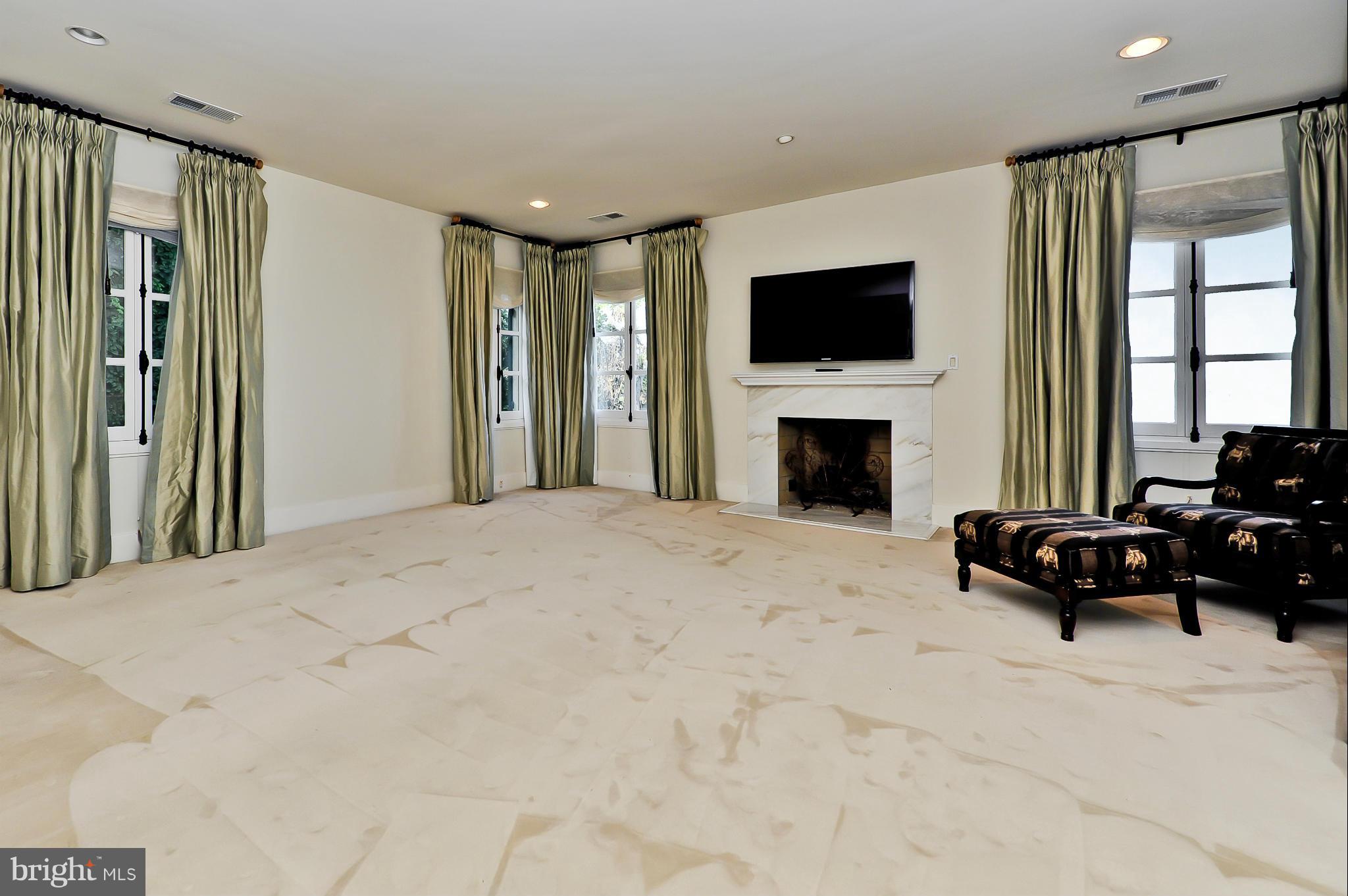 7608 Southdown Road Alexandria, VA 22308 - Photo 21 of 30 a living room with furniture fireplace and flat screen tv