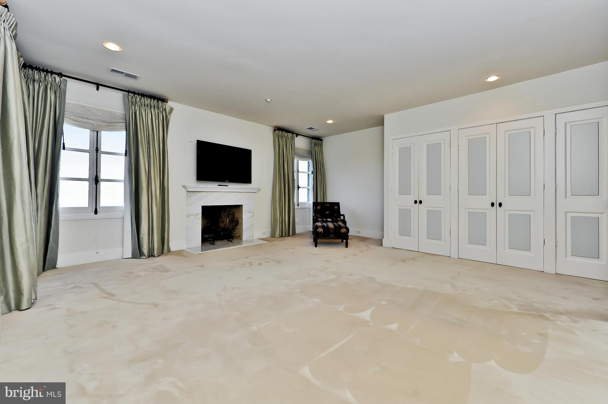 7608 Southdown Road Alexandria, VA 22308 - Photo 22 of 30 a view of an empty room with a fireplace and a window
