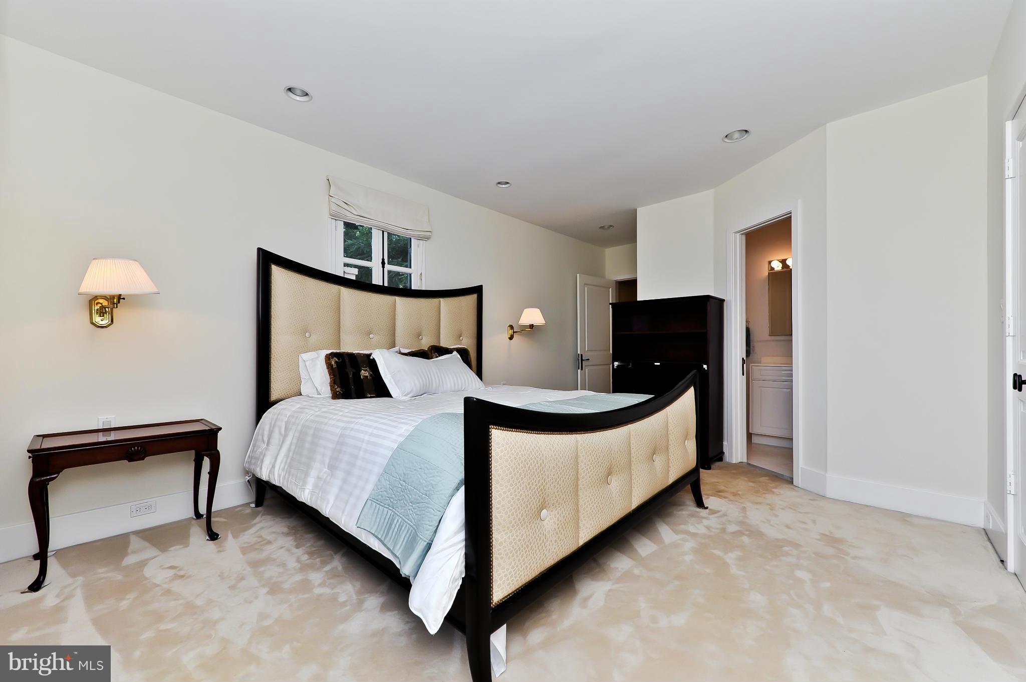 7608 Southdown Road Alexandria, VA 22308 - Photo 25 of 30 a bed room with a bed and a lamp