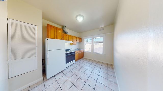 a kitchen with stainless steel appliances a refrigerator and a window
