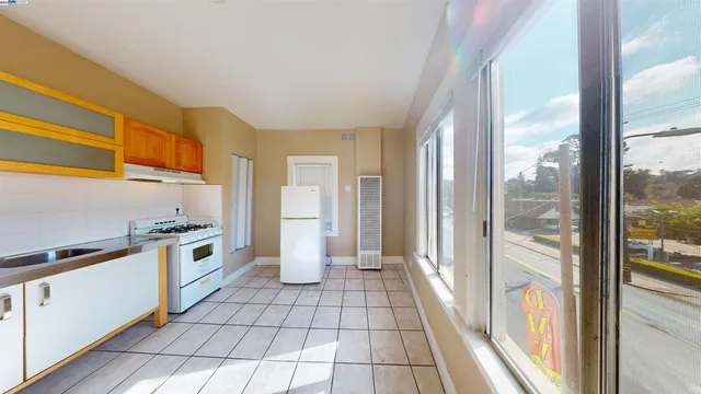 a kitchen with stainless steel appliances granite countertop a refrigerator and a stove