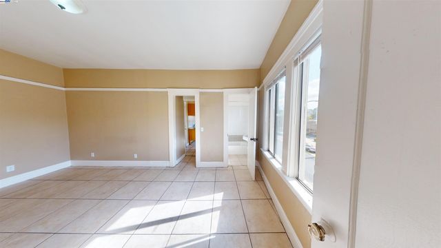 a view of a room with an empty space and a window