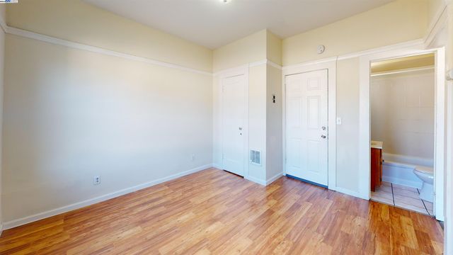 a view of room with wooden floor