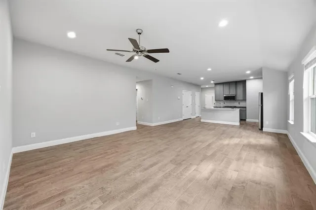 a view of a kitchen with a sink and stainless steel appliances