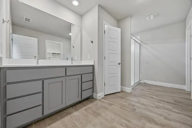 a bathroom with a double vanity sink and mirror