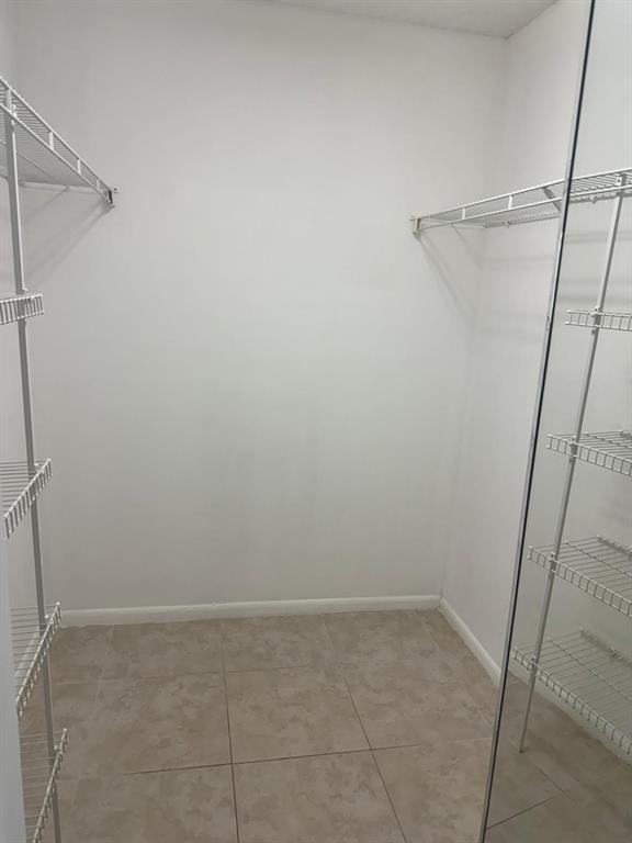 12551 Southwest 16th Court, Unit 306C Pembroke Pines, FL 33027 - Photo 11 of 16 a view of a room with racks on the wall