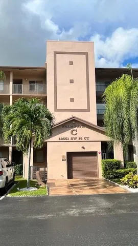 a view of a house with a yard and street