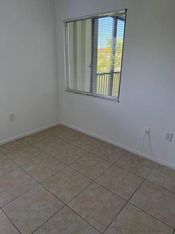 12551 Southwest 16th Court, Unit 306C Pembroke Pines, FL 33027 - Photo 8 of 16 an empty room with a window