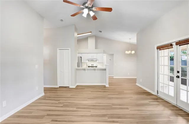 a view of a kitchen with wooden floor a sink and a window