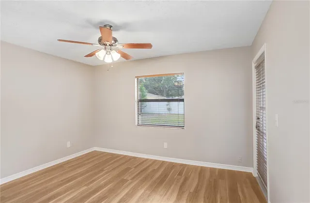 wooden floor in an empty room with a window