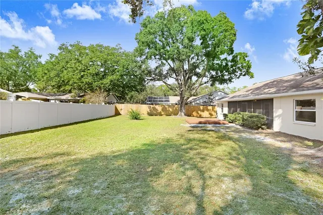 a view of a house with backyard and sitting area