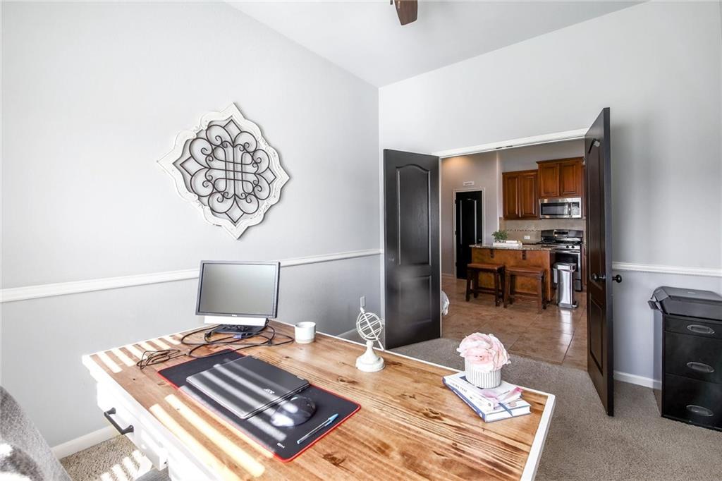 4640 Tiddle Lane Pflugerville, TX 78660 - Photo 14 of 21 a bedroom with a bed and a chandelier