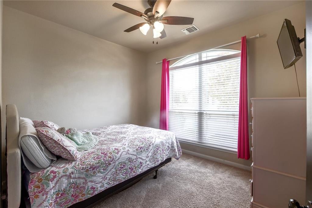 4640 Tiddle Lane Pflugerville, TX 78660 - Photo 17 of 21 a bedroom with a bed and a window