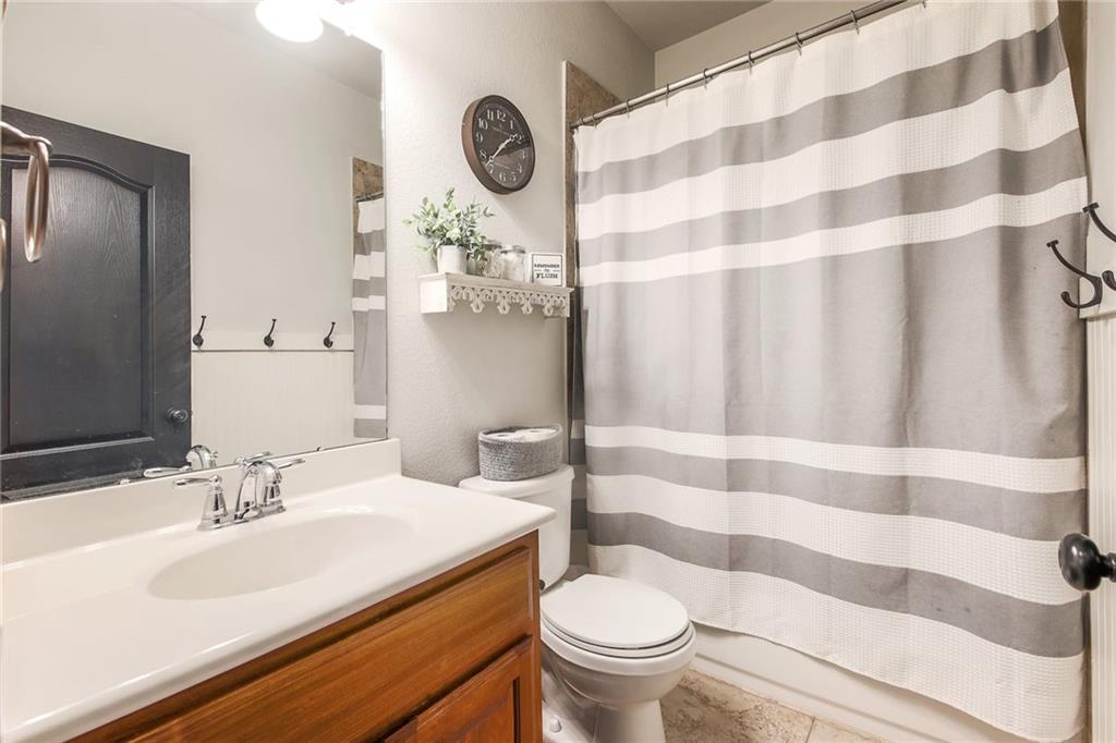 4640 Tiddle Lane Pflugerville, TX 78660 - Photo 18 of 21 a bathroom with a sink and a mirror