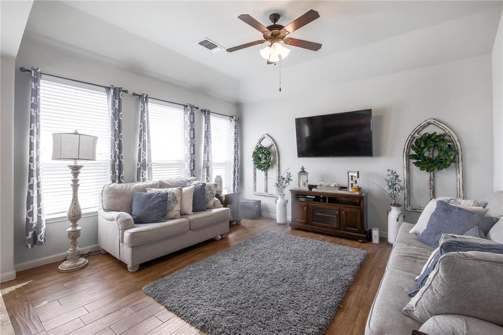 4640 Tiddle Lane Pflugerville, TX 78660 - Photo 3 of 21 a living room with furniture and a flat screen tv