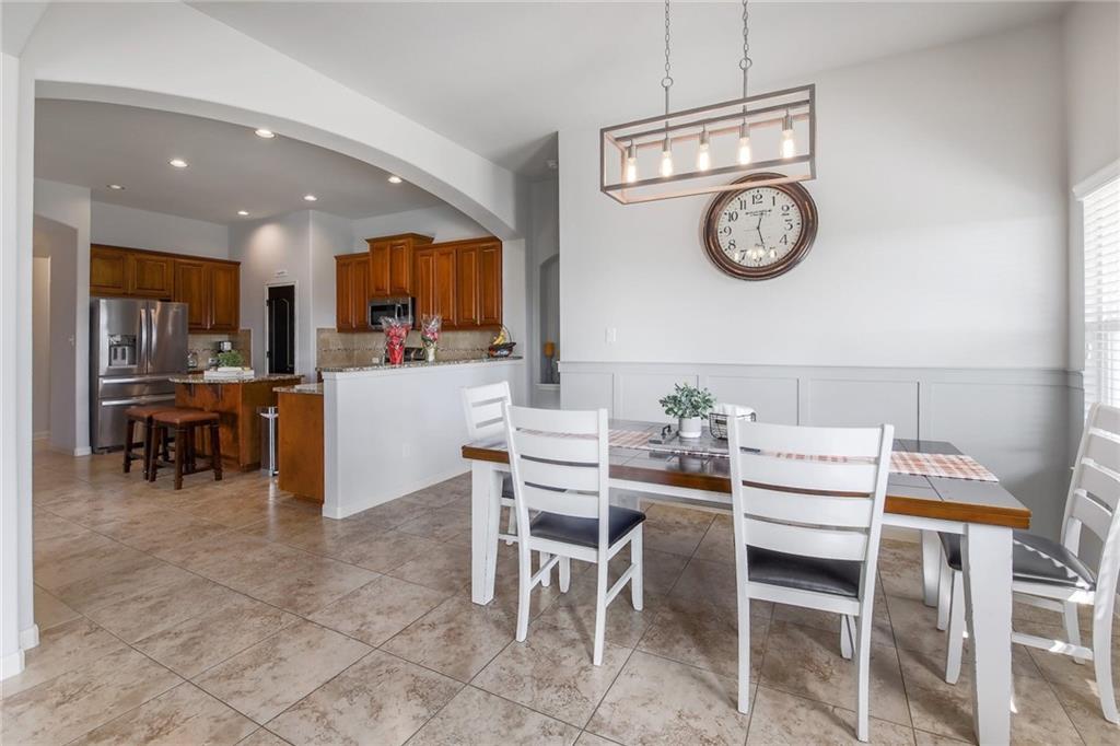 4640 Tiddle Lane Pflugerville, TX 78660 - Photo 5 of 21 a dining area with a table chairs and a clock