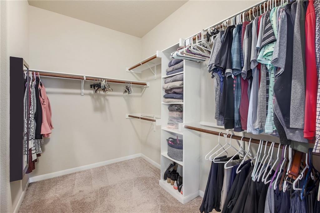 4640 Tiddle Lane Pflugerville, TX 78660 - Photo 10 of 21 a view of walk in closet with clothes
