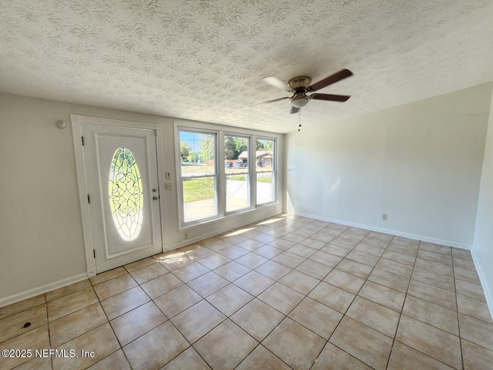 11547 Emuness Road Jacksonville, FL 32218 - Photo 11 of 16 a view of an empty room with a window