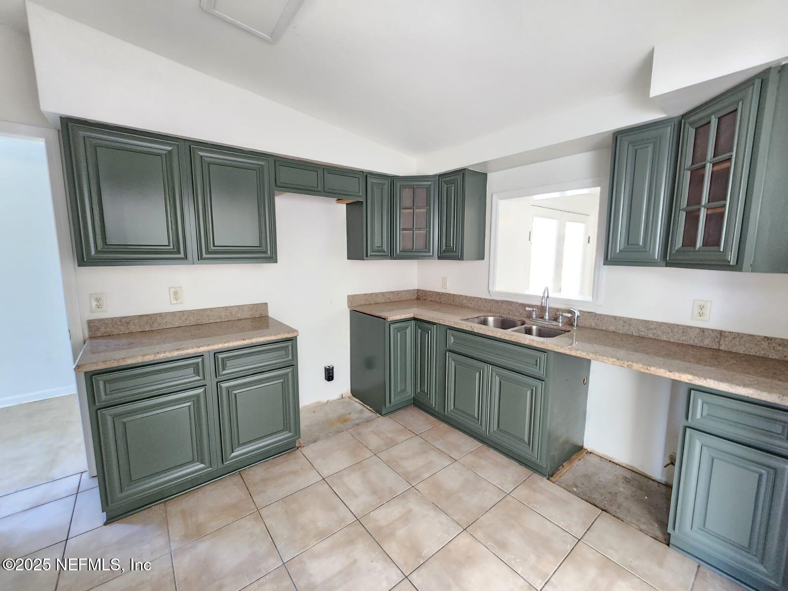 11547 Emuness Road Jacksonville, FL 32218 - Photo 13 of 16 a kitchen with a sink and a stove top oven