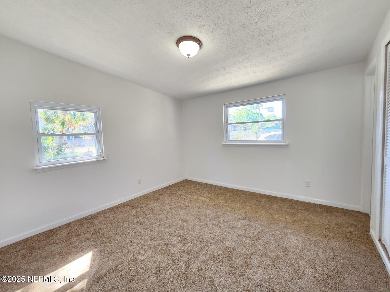 11547 Emuness Road Jacksonville, FL 32218 - Photo 16 of 16 an empty room with windows