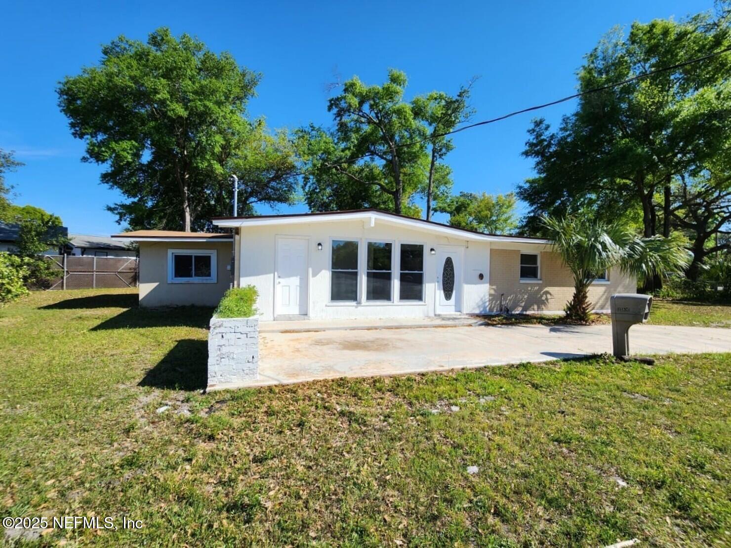 11547 Emuness Road Jacksonville, FL 32218 - Photo 2 of 16 a front view of a house with a yard