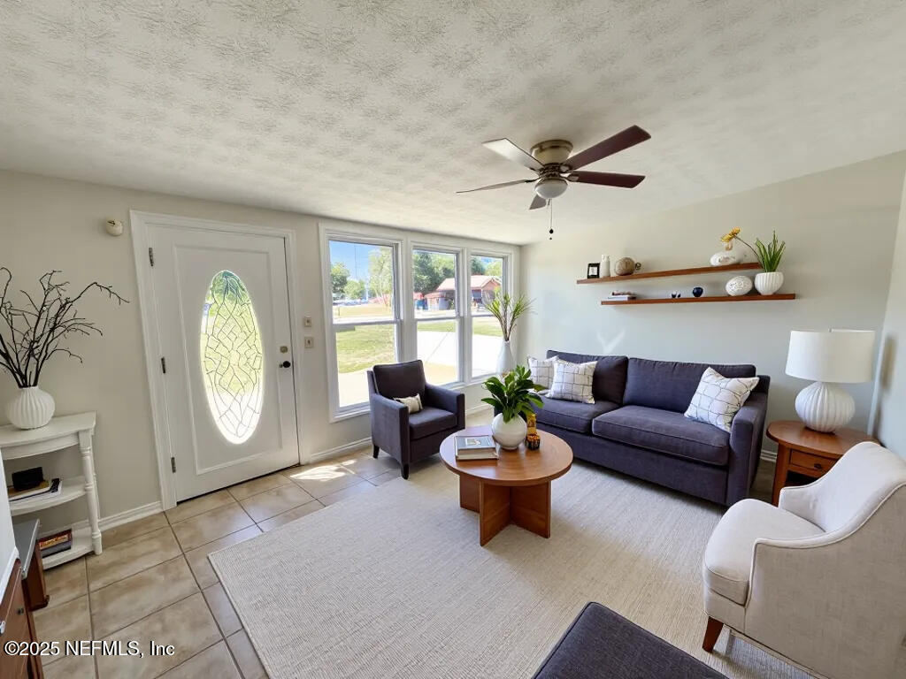 11547 Emuness Road Jacksonville, FL 32218 - Photo 3 of 16 a living room with furniture a rug and a window