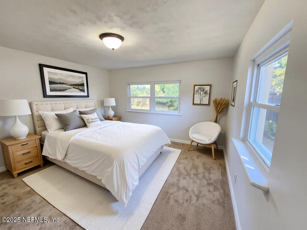 11547 Emuness Road Jacksonville, FL 32218 - Photo 6 of 16 a bedroom with a bed and a painting on the wall