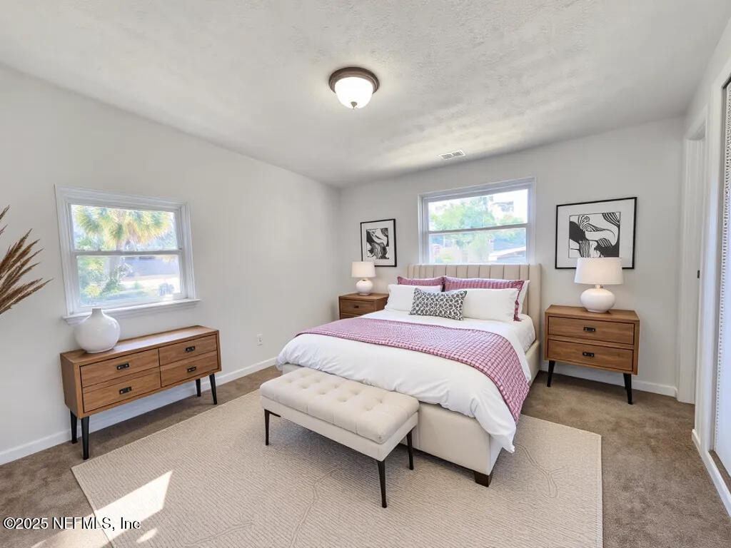 11547 Emuness Road Jacksonville, FL 32218 - Photo 8 of 16 a spacious bedroom with a bed and a window