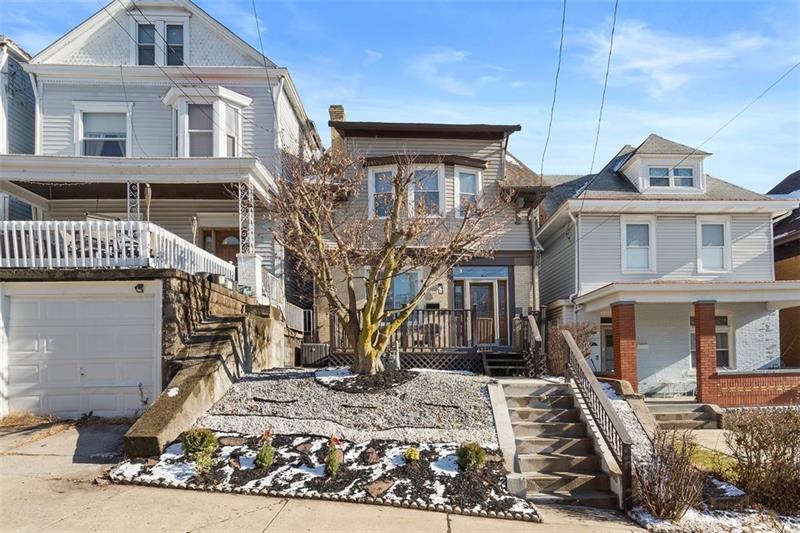 a view of a white house with large windows