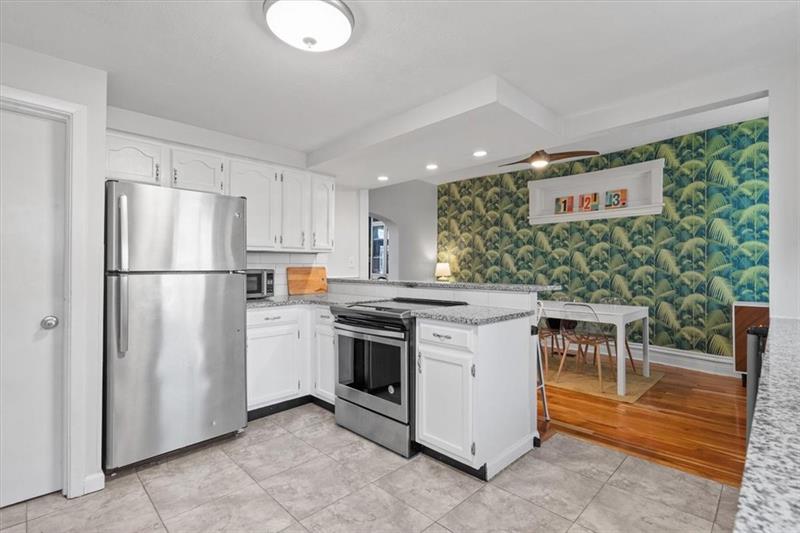 89 Craighead Street Pittsburgh, PA 15211 - Photo 15 of 29 a kitchen with a refrigerator and a stove top oven
