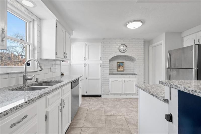 89 Craighead Street Pittsburgh, PA 15211 - Photo 17 of 29 a kitchen with a sink stove and refrigerator