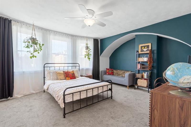 89 Craighead Street Pittsburgh, PA 15211 - Photo 18 of 29 a bedroom with a bed and a chandelier