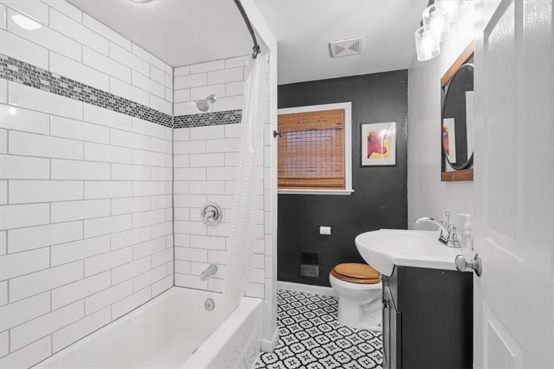 89 Craighead Street Pittsburgh, PA 15211 - Photo 24 of 29 a bathroom with a sink a toilet and shower