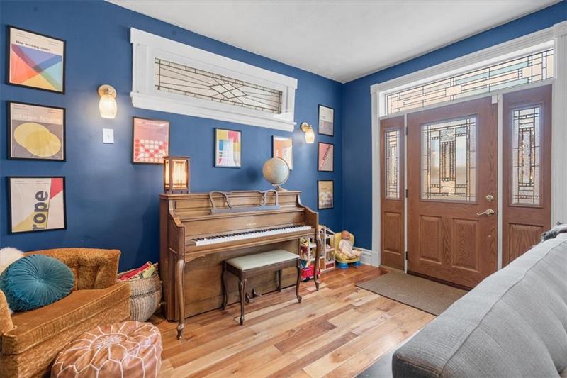 89 Craighead Street Pittsburgh, PA 15211 - Photo 3 of 29 a bedroom with furniture and a wooden floor