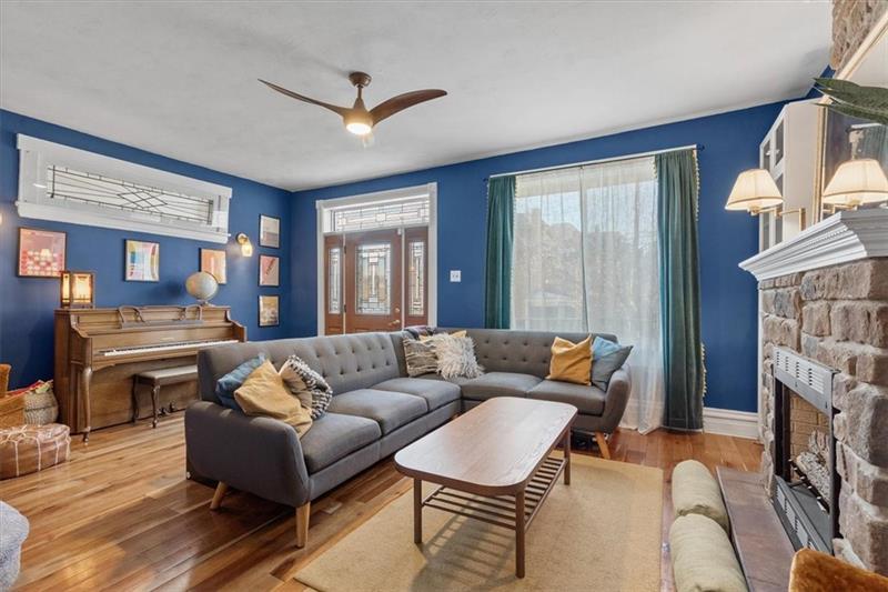 89 Craighead Street Pittsburgh, PA 15211 - Photo 7 of 29 a living room with furniture a fireplace and a window
