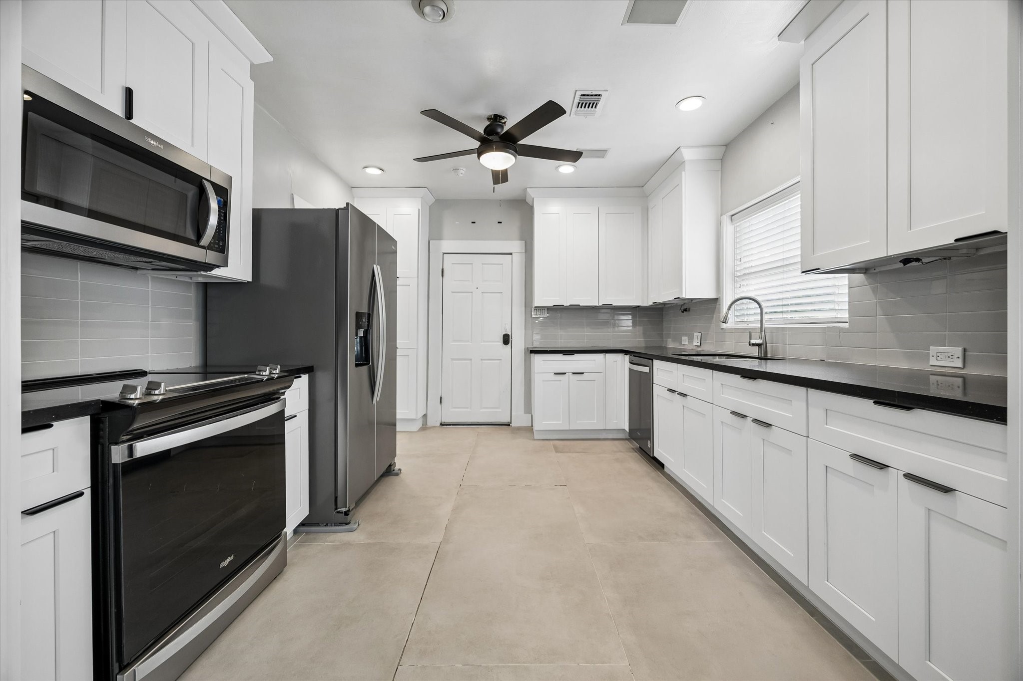1201 Tulane Street Houston, TX 77008 - Photo 14 of 31 The updated kitchen brings a fresh, polished feel to this 1930s Craftsman with crisp white cabinetry, stainless steel appliances, sleek granite counters, stylish tile backsplash, recessed lighting, and plenty of storage. It is bright, functional, and ready for weeknight dinners, weekend brunch, and everything in between.
