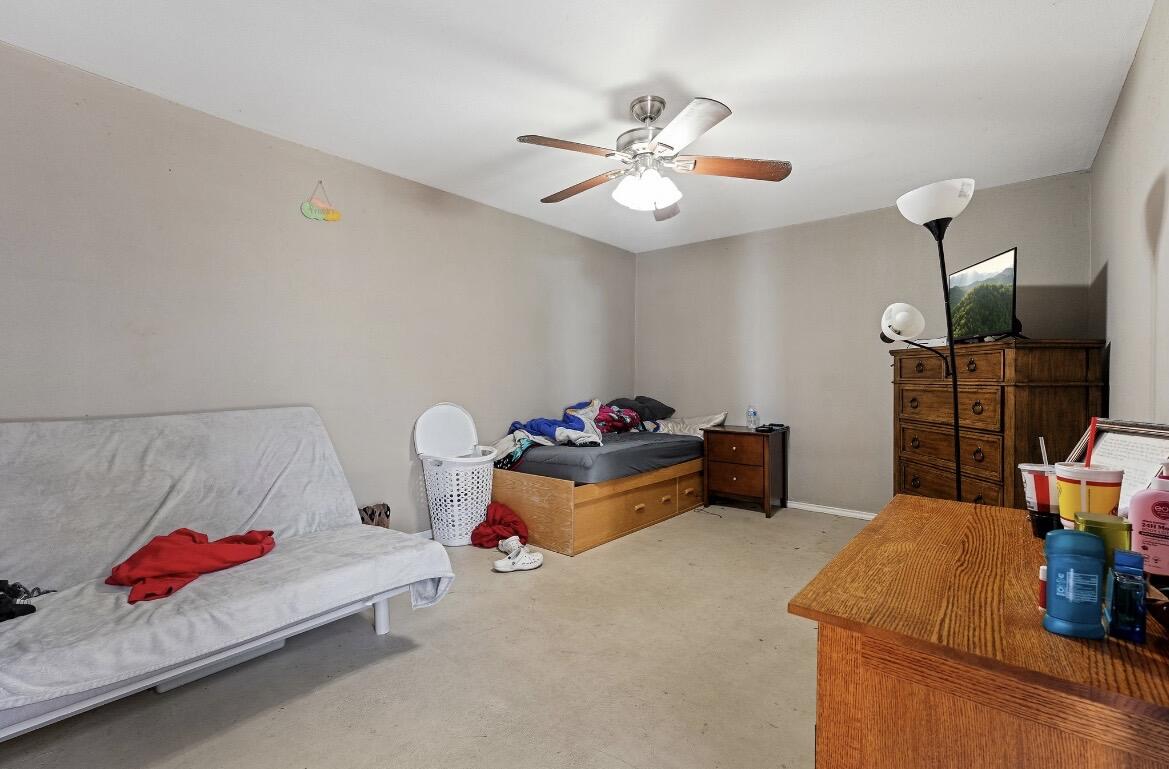 2511 28th Street Lubbock, TX 79410 - Photo 11 of 15 a bedroom with furniture and a chandelier