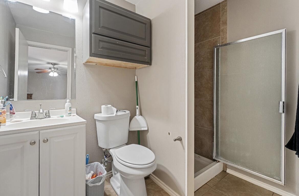 2511 28th Street Lubbock, TX 79410 - Photo 13 of 15 a view of bathroom with a toilet sink and mirror