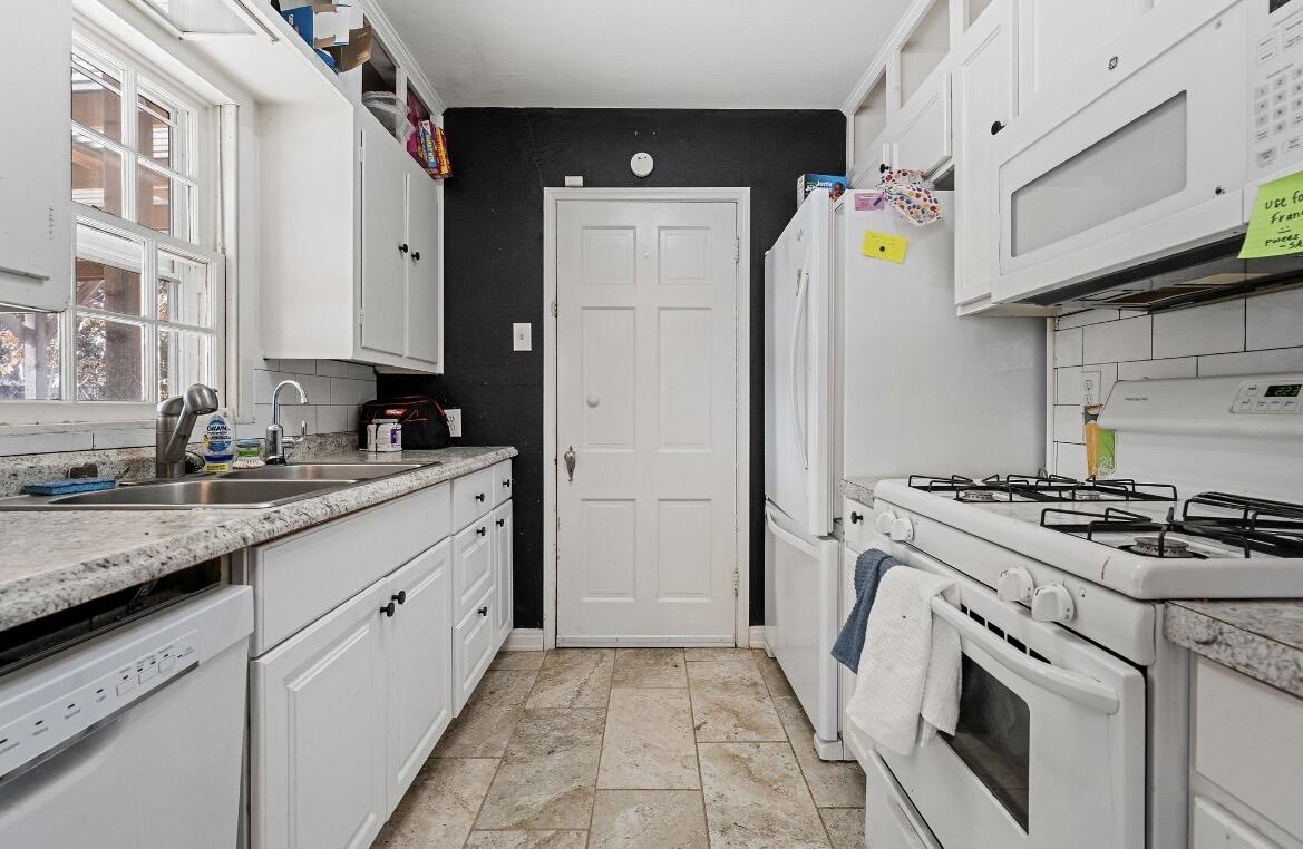 2511 28th Street Lubbock, TX 79410 - Photo 4 of 15 a kitchen with a stove a sink and a refrigerator