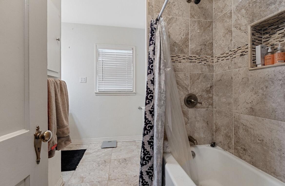 2511 28th Street Lubbock, TX 79410 - Photo 7 of 15 a bathroom with a bathtub and a shower
