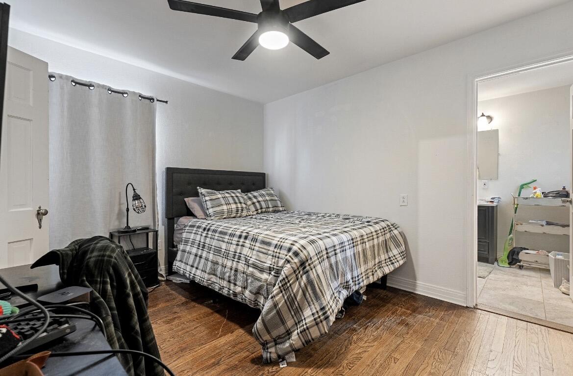 2511 28th Street Lubbock, TX 79410 - Photo 8 of 15 a bedroom with a bed and wooden floor