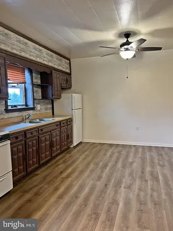 a living room with stainless steel appliances kitchen island granite countertop furniture and a kitchen view